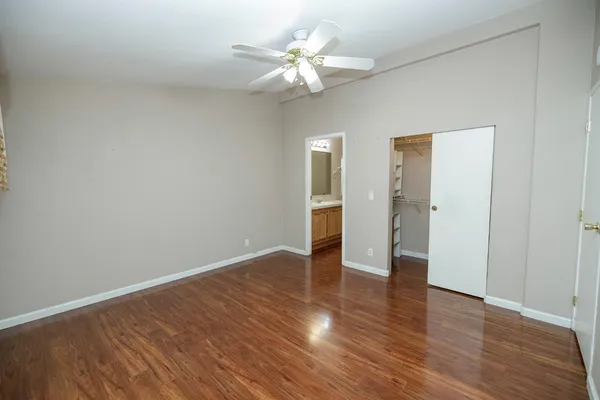 a view of an empty room with wooden floor