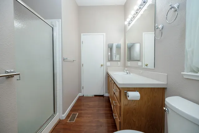 a bathroom with a sink and mirror with toilet