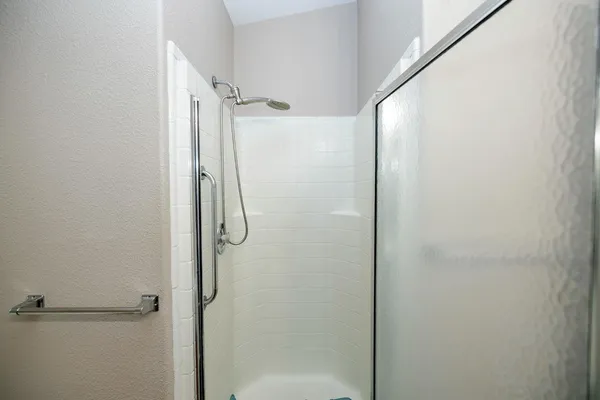 a bathroom with a glass shower door