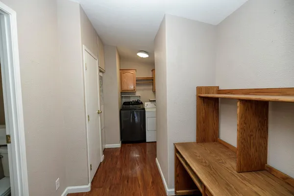 a view of hallway with wooden floor