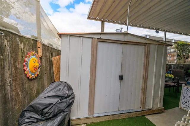 a view of a two chairs in the patio
