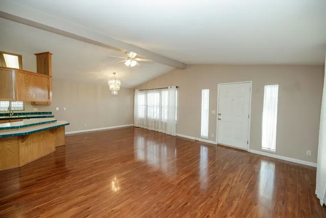 a view of a room with wooden floor and a window