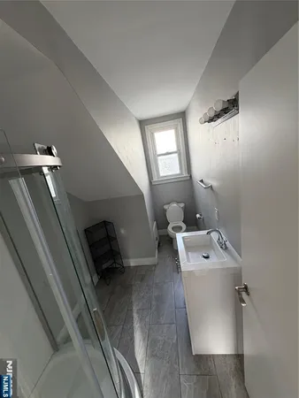 a view of a room with wooden floor and window