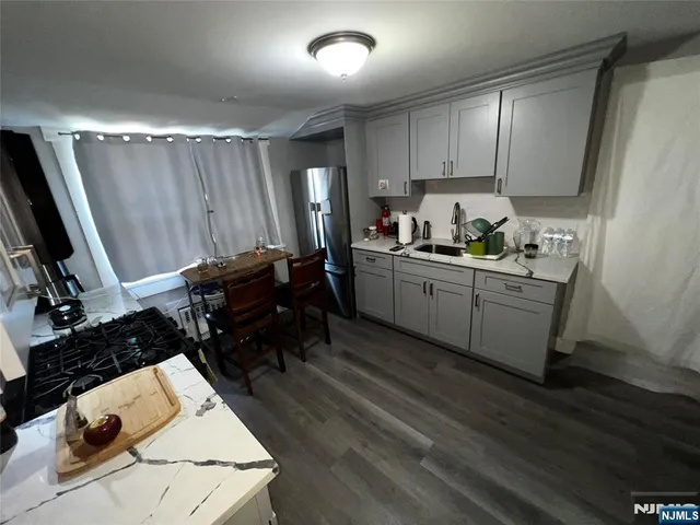 a kitchen with sink refrigerator and cabinets