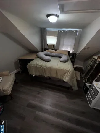 a bedroom with bed couch and window