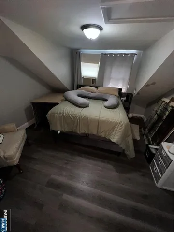 a bedroom with bed couch and window