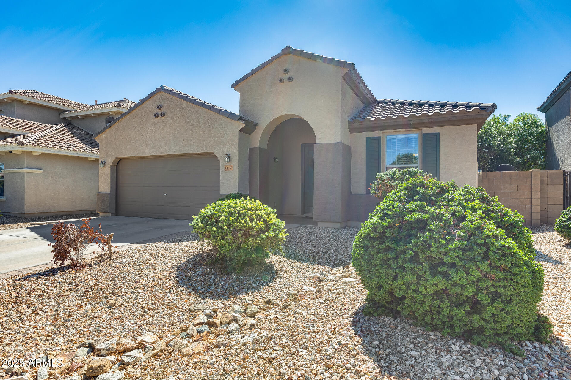 14229 West Calavar Road Surprise, AZ 85379 - Photo 1 of 44 a front view of a house with garden
