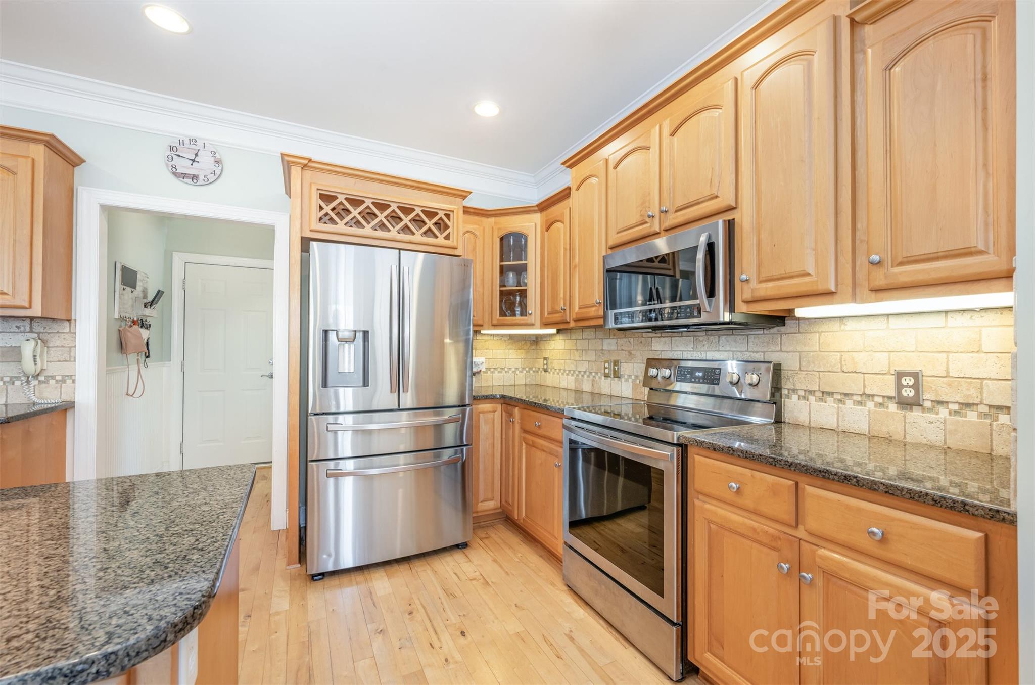 9467 Hester Court Harrisburg, NC 28075 - Photo 11 of 48 a kitchen with stainless steel appliances granite countertop a refrigerator a stove top oven a sink and dishwasher