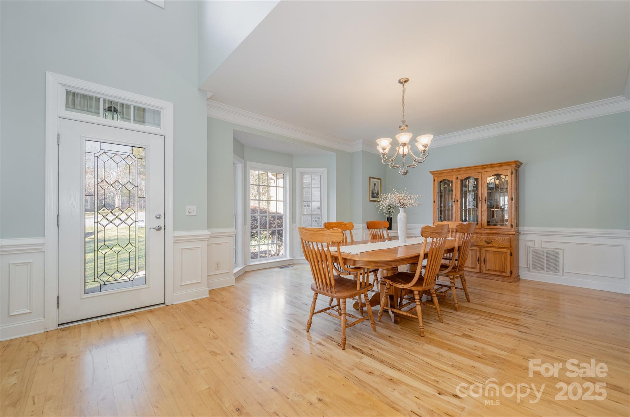 9467 Hester Court Harrisburg, NC 28075 - Photo 14 of 48 a dining room with furniture a chandelier and wooden floor