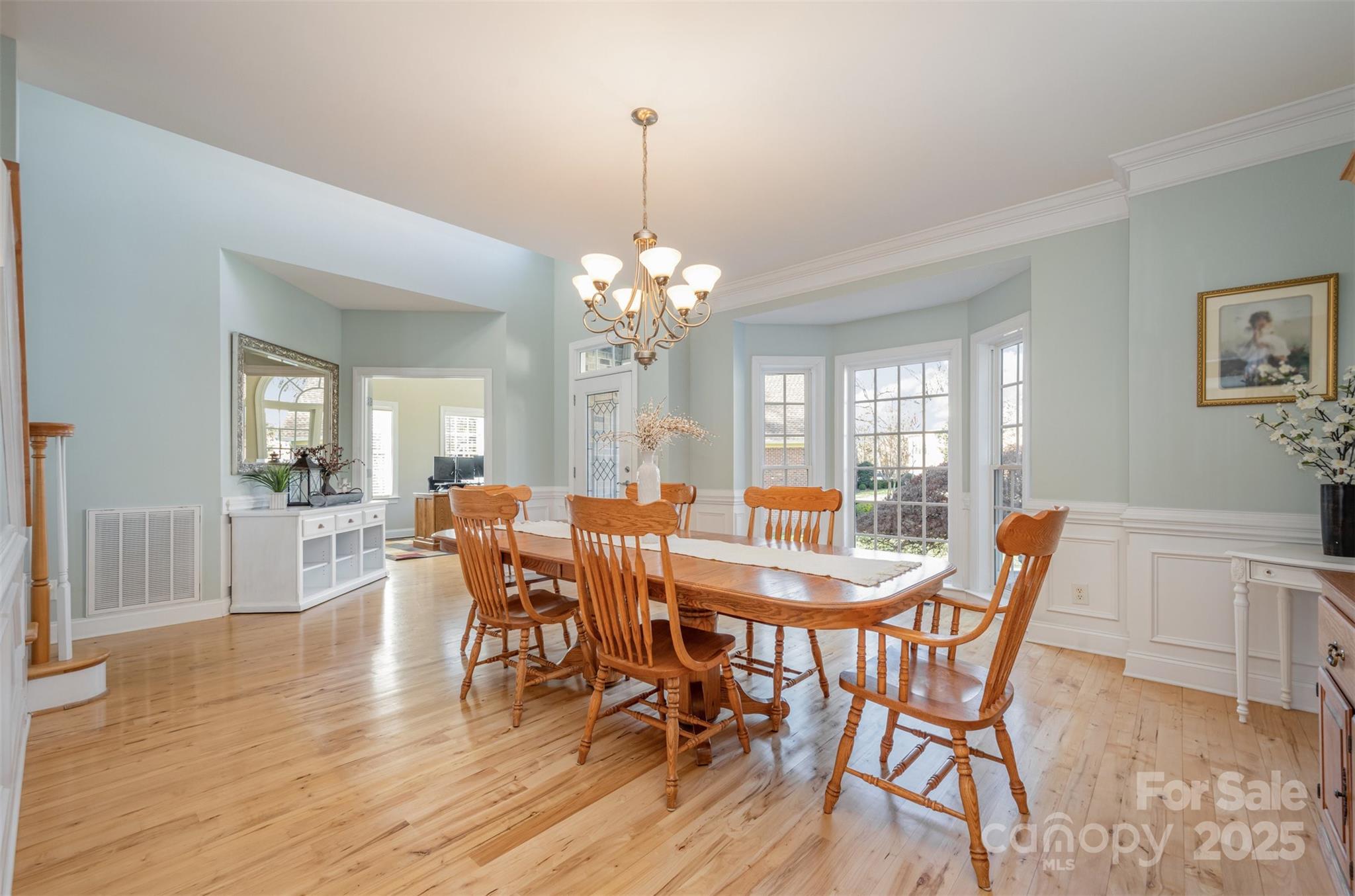 9467 Hester Court Harrisburg, NC 28075 - Photo 15 of 48 a view of a dining room with furniture and wooden floor