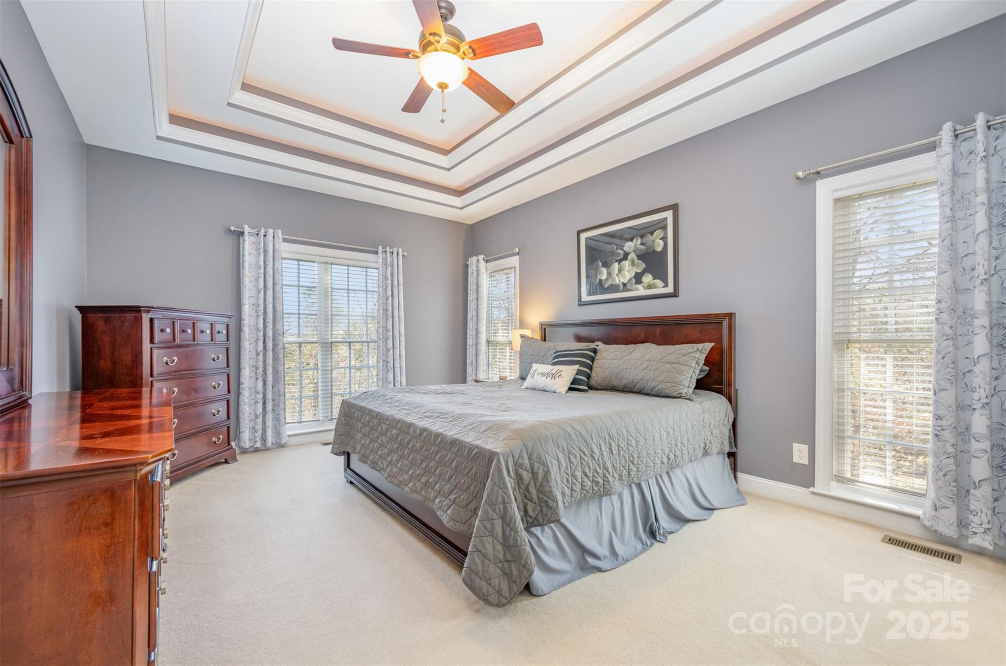 9467 Hester Court Harrisburg, NC 28075 - Photo 19 of 48 a spacious bedroom with a bed and a chandelier