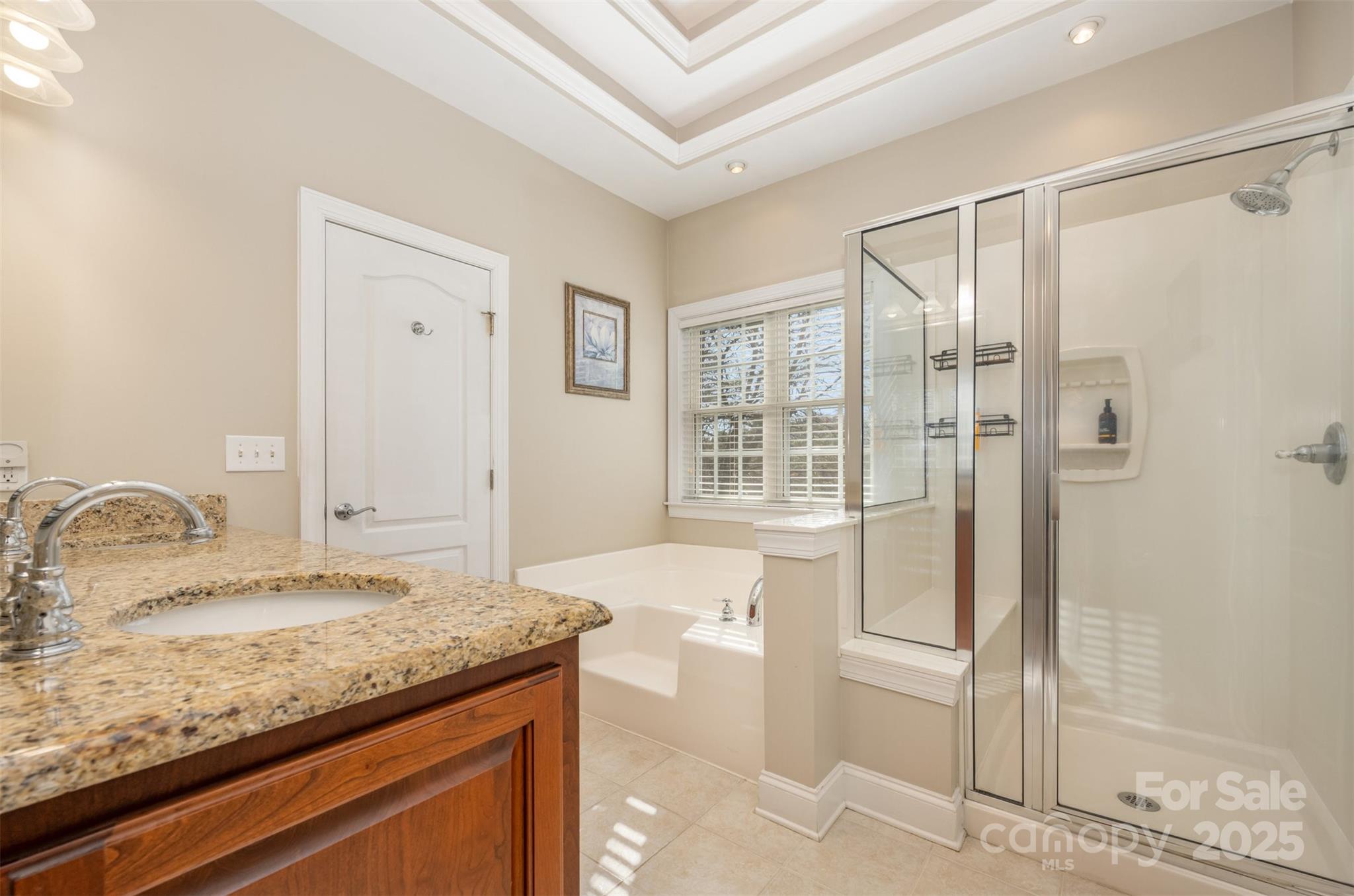 9467 Hester Court Harrisburg, NC 28075 - Photo 22 of 48 a bathroom with a granite countertop sink and shower