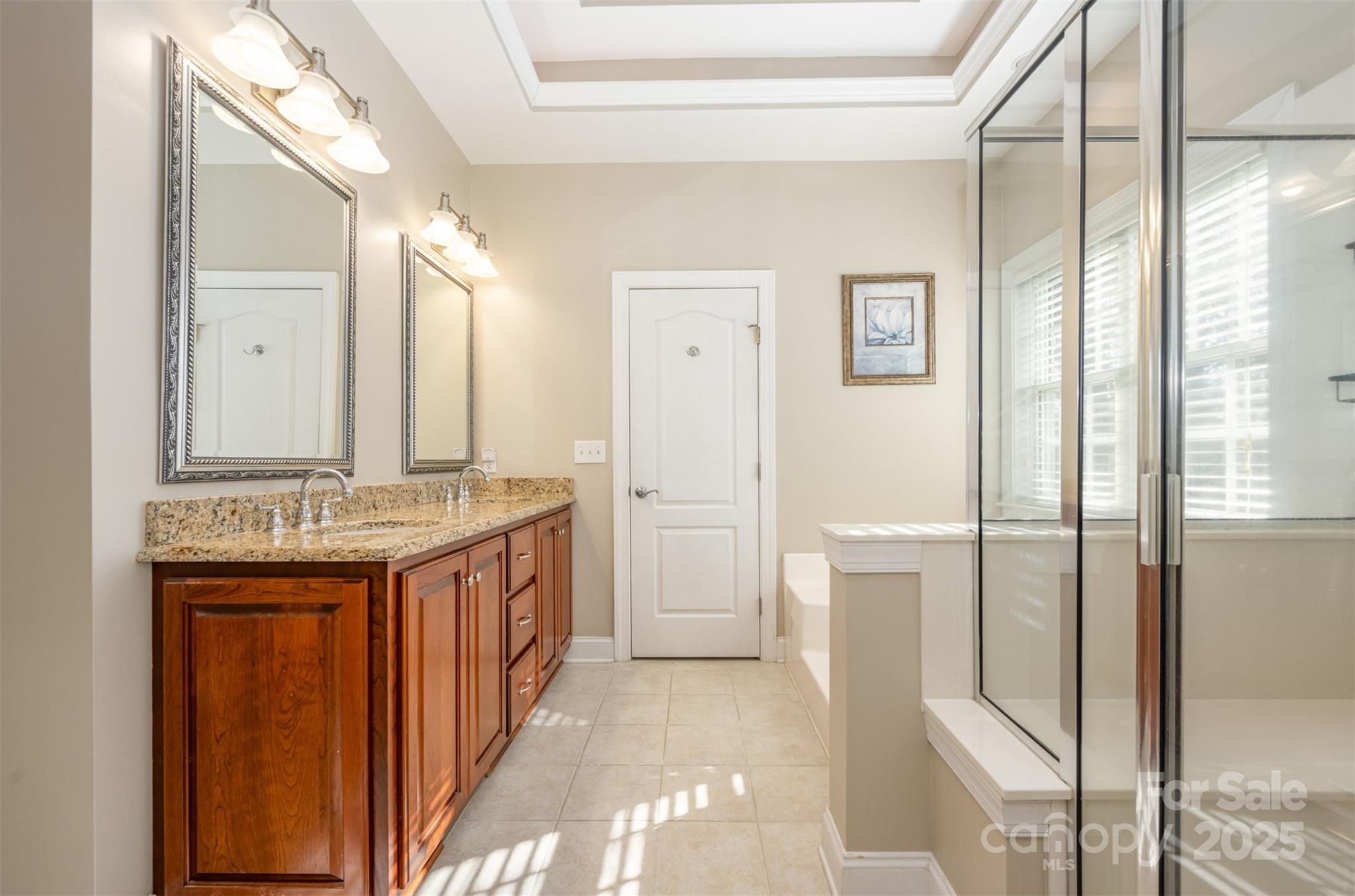 9467 Hester Court Harrisburg, NC 28075 - Photo 23 of 48 a bathroom with a granite countertop sink and a mirror