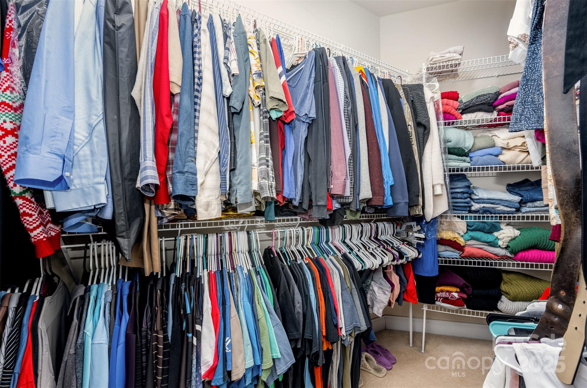 9467 Hester Court Harrisburg, NC 28075 - Photo 24 of 48 a view of walk in closet with clothes