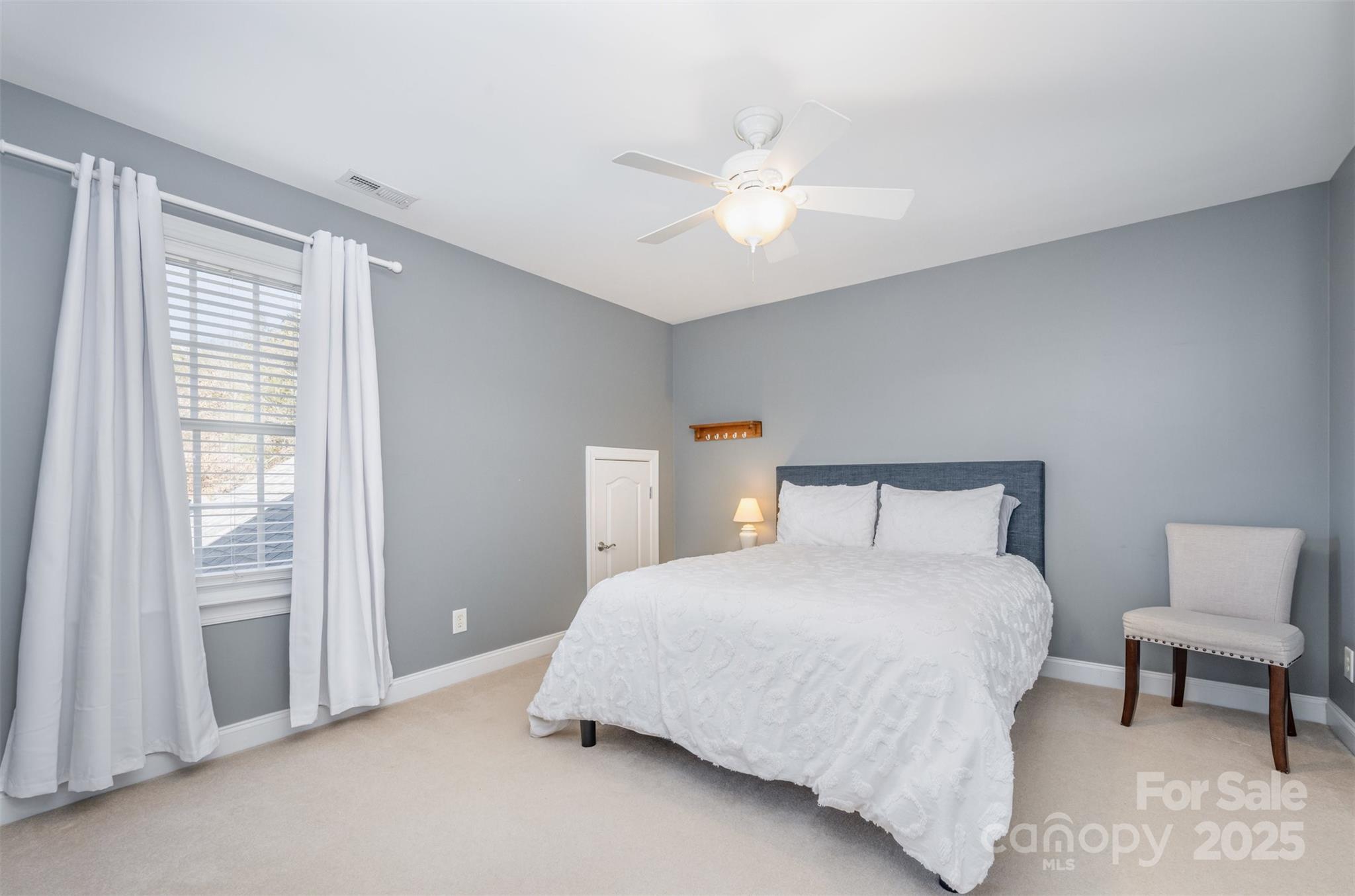 9467 Hester Court Harrisburg, NC 28075 - Photo 26 of 48 a bedroom with a bed and a chandelier