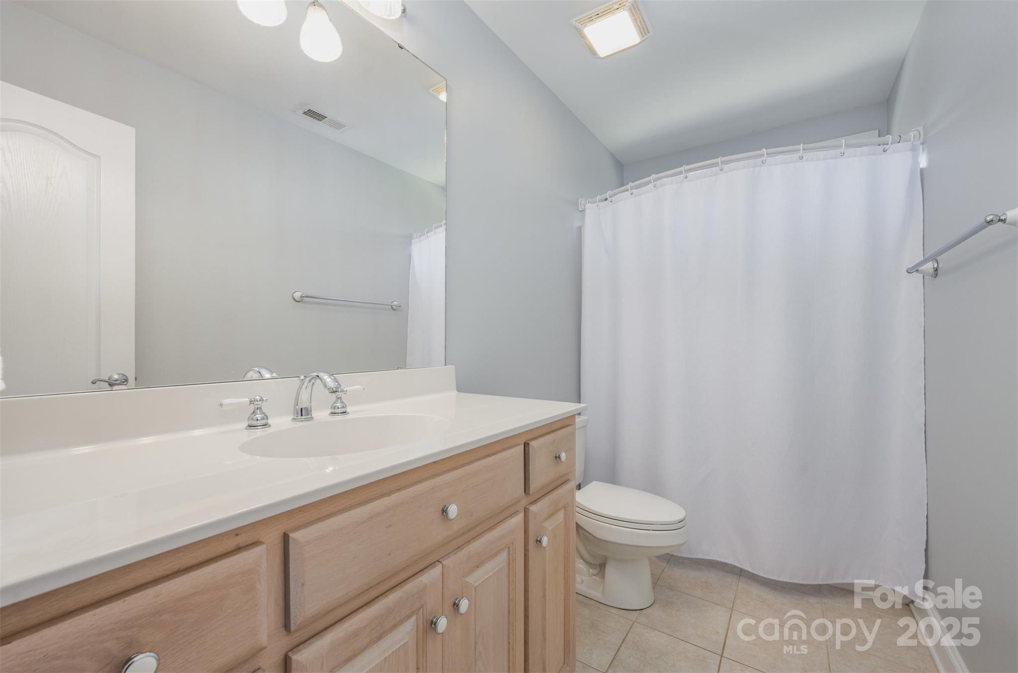 9467 Hester Court Harrisburg, NC 28075 - Photo 27 of 48 a bathroom with a sink toilet a mirror and shower