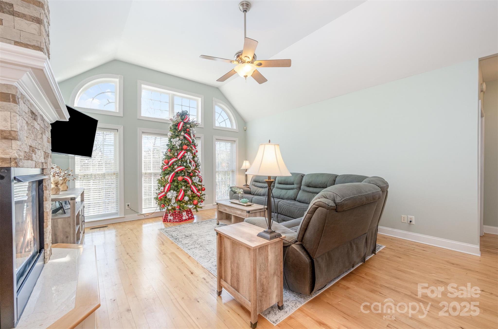 9467 Hester Court Harrisburg, NC 28075 - Photo 5 of 48 a living room with furniture and a flat screen tv