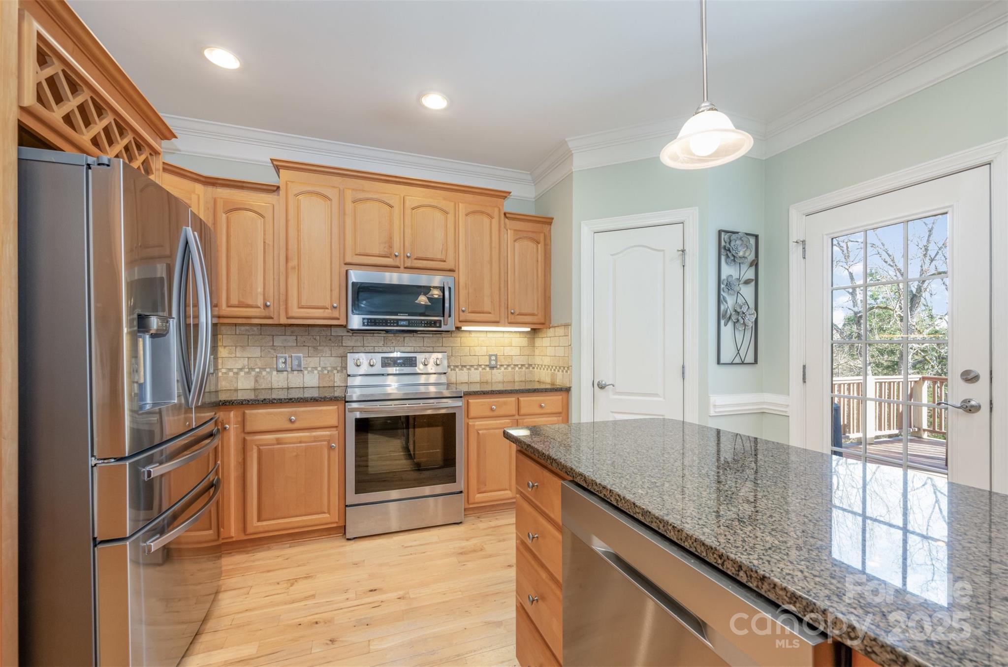 9467 Hester Court Harrisburg, NC 28075 - Photo 10 of 48 a kitchen with stainless steel appliances granite countertop a stove top oven a sink and dishwasher