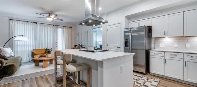 a kitchen with stainless steel appliances granite countertop furniture and a refrigerator