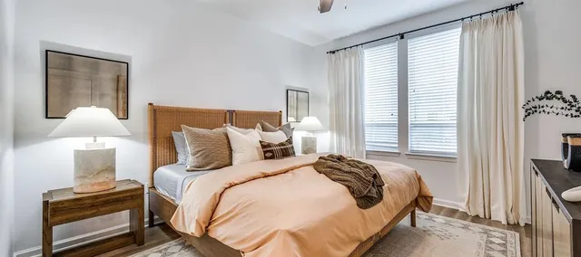 a bedroom with a bed and a night stand