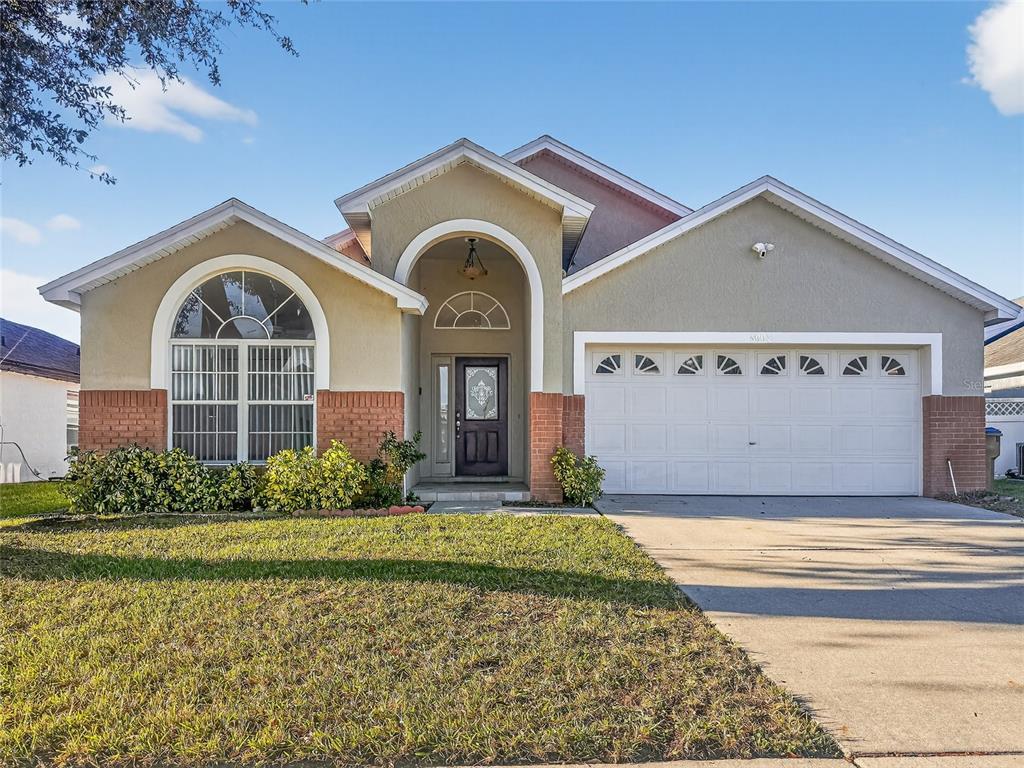8003 Bow Creek Road Kissimmee, FL 34747 - Photo 1 of 1 a front view of a house with a yard