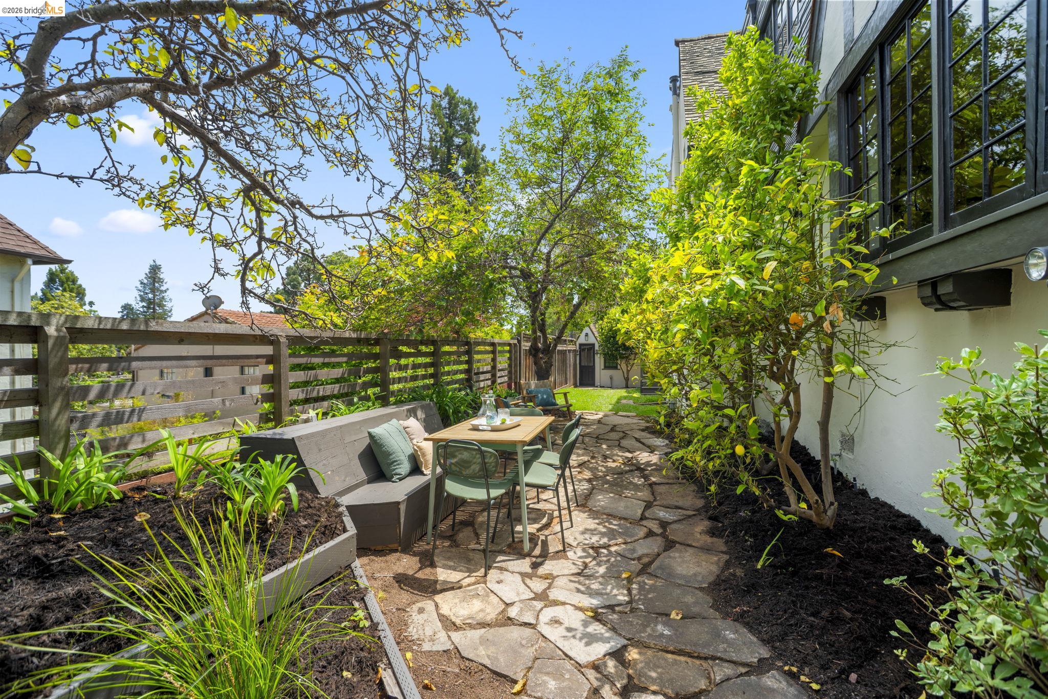 1087 Hubert Road Oakland, CA 94610 - Photo 53 of 67 Flagstone patio area with a built-in concrete bench