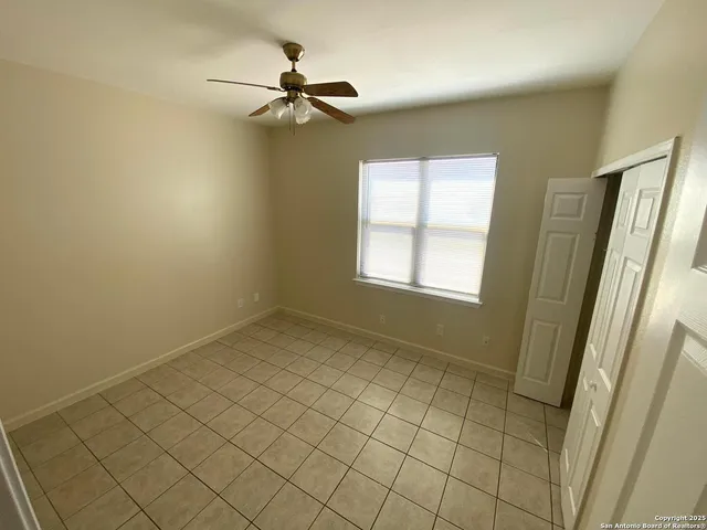 a view of an empty room and a window