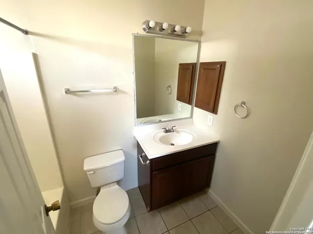 a bathroom with a sink toilet and mirror