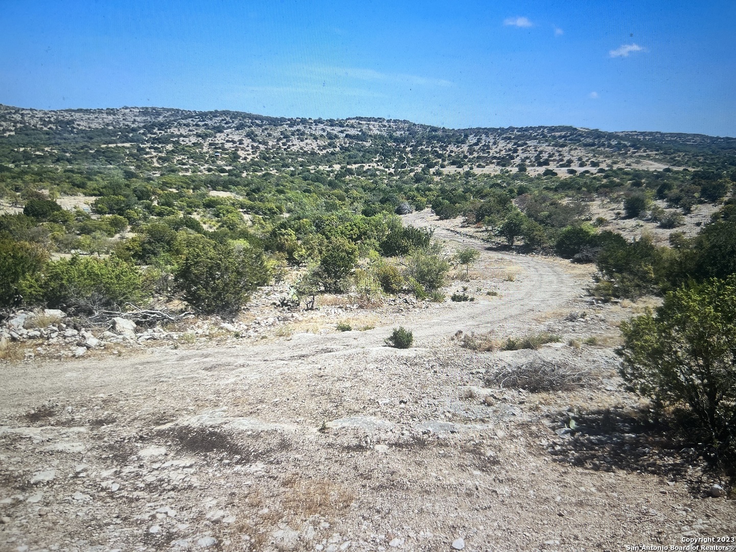 7687 County Road 450 Rocksprings, TX 78880 - Photo 5 of 17 a view of a beach with a mountain in the background
