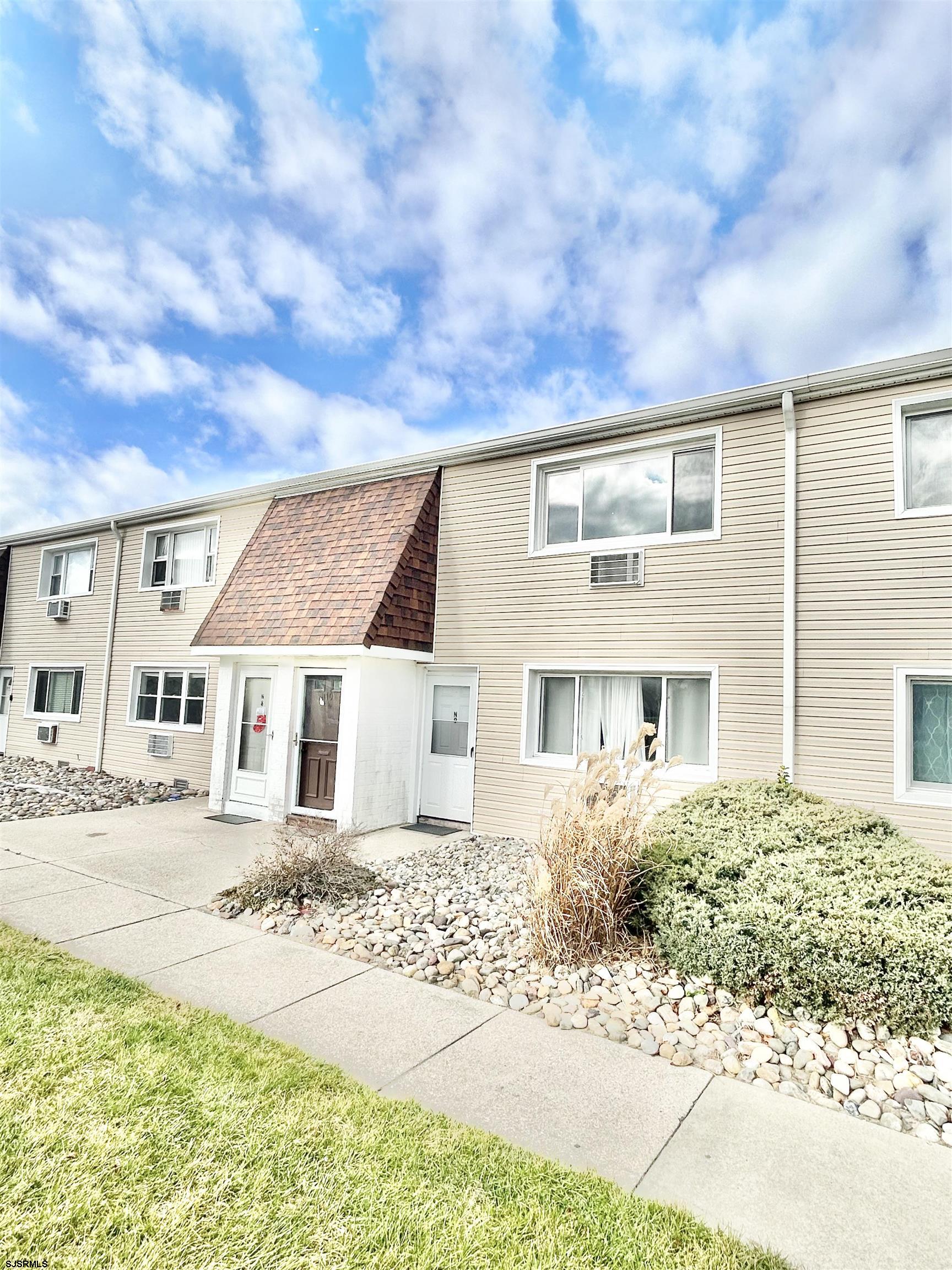 4901 Harbor Beach Boulevard, Unit N10 Brigantine, NJ 08203 - Photo 1 of 17 a front view of a house with a yard