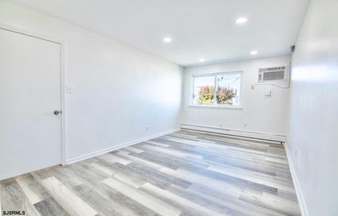 4901 Harbor Beach Boulevard, Unit N10 Brigantine, NJ 08203 - Photo 12 of 17 a view of empty room with wooden floor