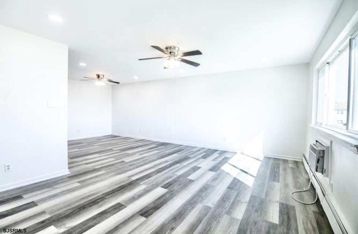 4901 Harbor Beach Boulevard, Unit N10 Brigantine, NJ 08203 - Photo 4 of 17 a view of empty room with wooden floor and fan