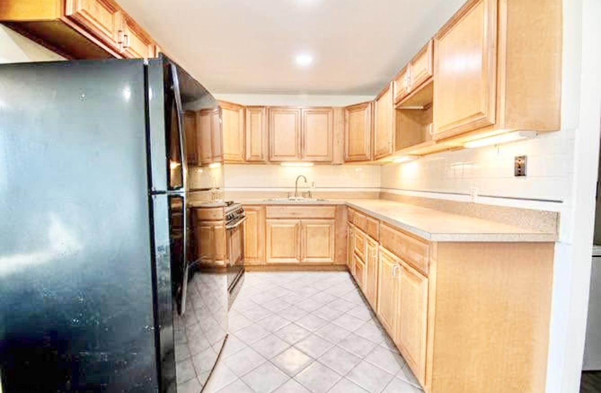 4901 Harbor Beach Boulevard, Unit N10 Brigantine, NJ 08203 - Photo 5 of 17 a kitchen with stainless steel appliances granite countertop a sink and cabinets