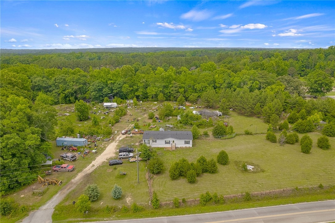 1549 Bethany Church Road Belton, SC 29627 - Photo 7 of 36 Perched on a verdant lot, a charming home awaits amidst a tranquil wooded landscape.