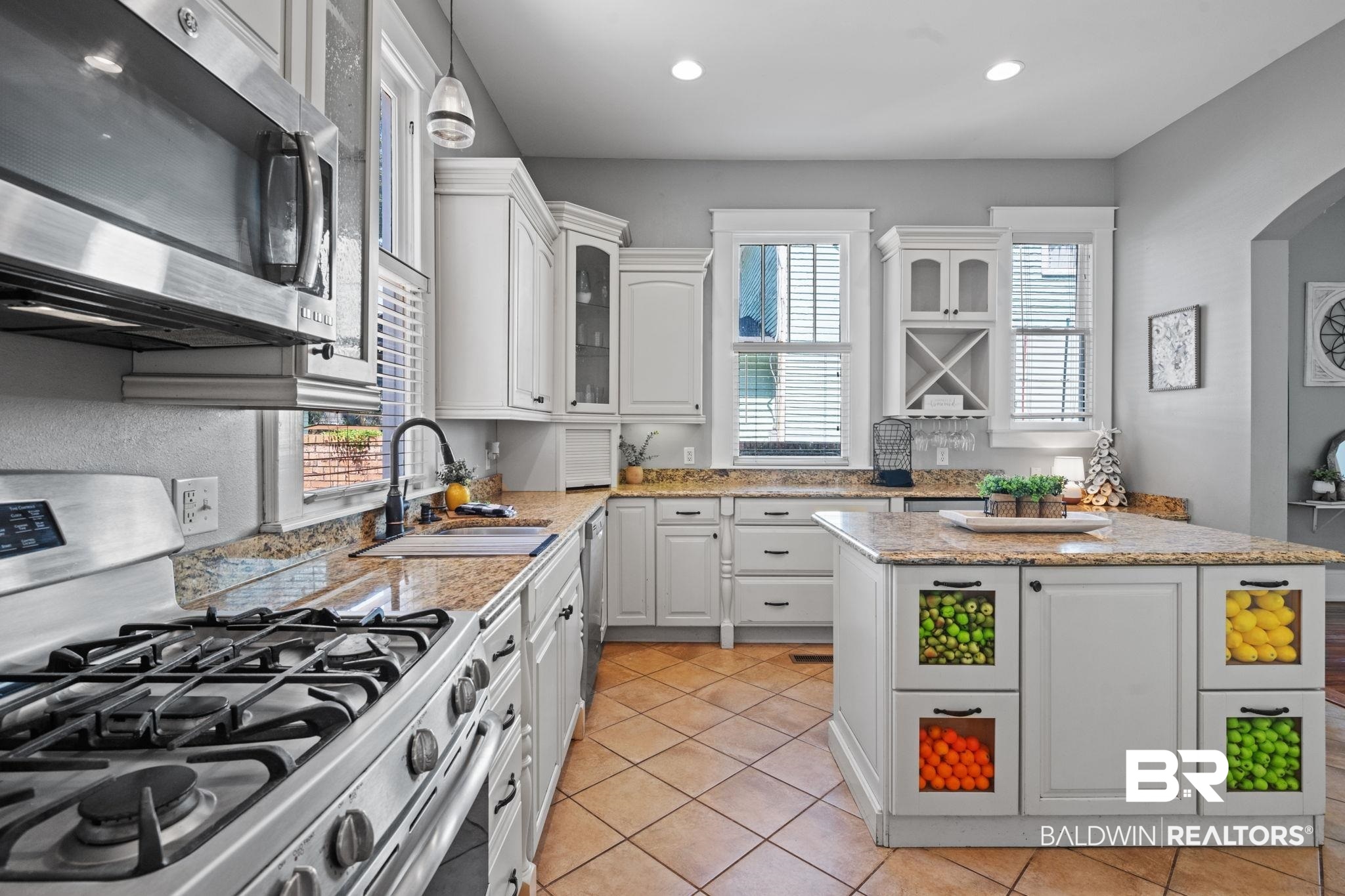10 South Monterey Street Mobile, AL 36604 - Photo 16 of 45 Kitchen featuring appliances with stainless steel finishes, white cabinets, light tile patterned flooring, glass insert cabinets, and recessed lighting