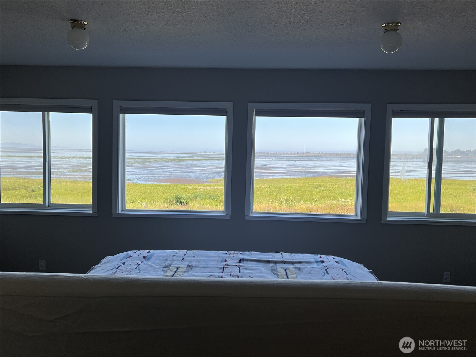 240 Stringtown Road Ilwaco, WA 98624 - Photo 11 of 39 a bedroom with a bed and window