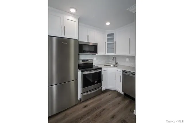 a kitchen with a refrigerator stove and microwave