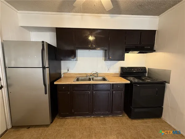 a kitchen with stainless steel appliances a stove and a refrigerator