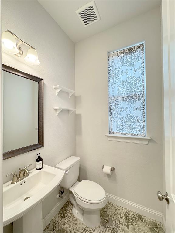 12407 Scottswood Road Frisco, TX 75035 - Photo 13 of 14 Half bath featuring toilet and tile patterned floors
