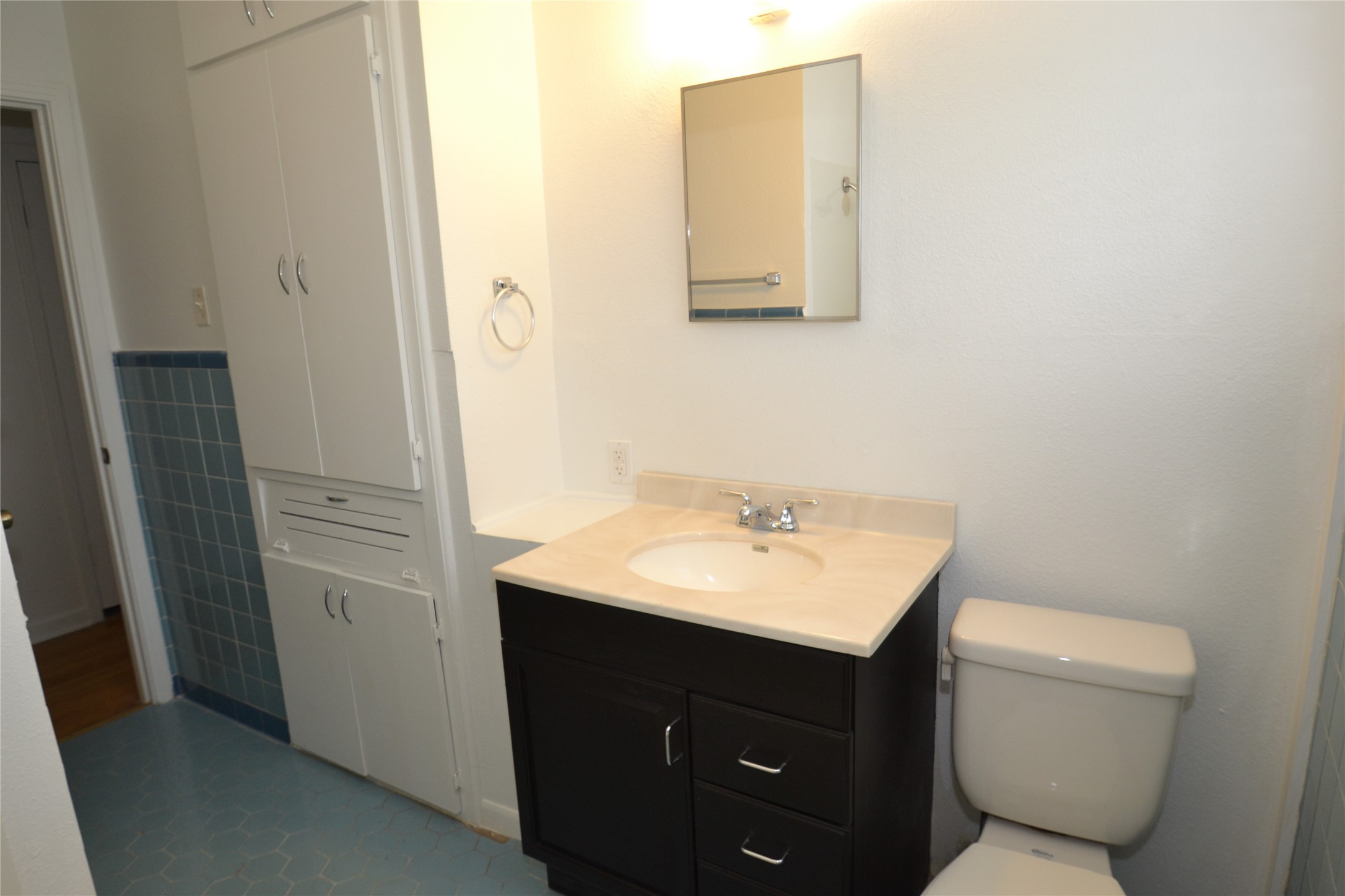 1211 Ridgemont Drive Austin, TX 78723 - Photo 15 of 28 a bathroom with a toilet sink vanity and mirror