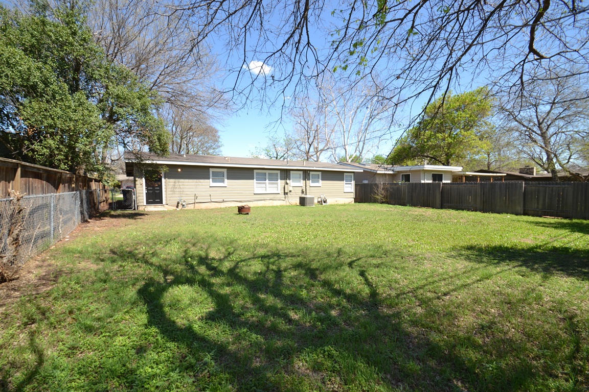 1211 Ridgemont Drive Austin, TX 78723 - Photo 24 of 28 a view of a house with a yard