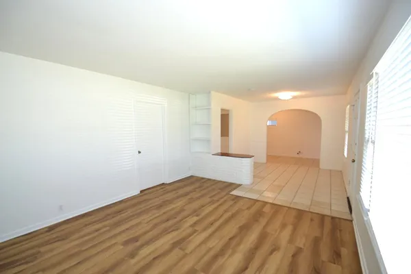 a view of a room with wooden floor and white walls
