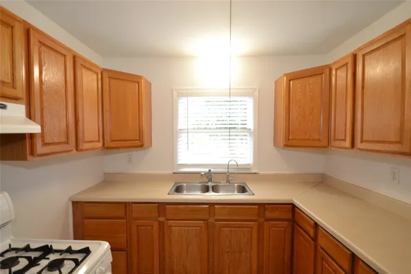 a kitchen with a sink cabinets and window