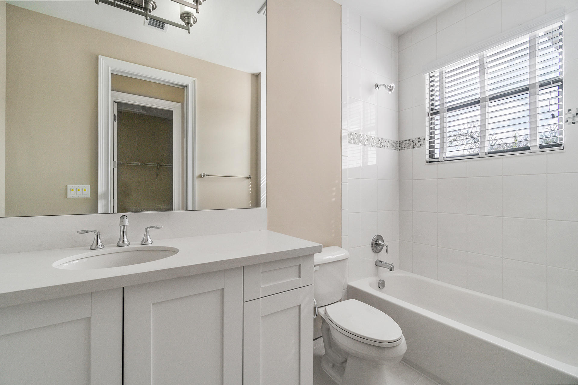 17334 Rosella Road Boca Raton, FL 33496 - Photo 16 of 50 a bathroom with a granite countertop toilet a sink and a bathtub