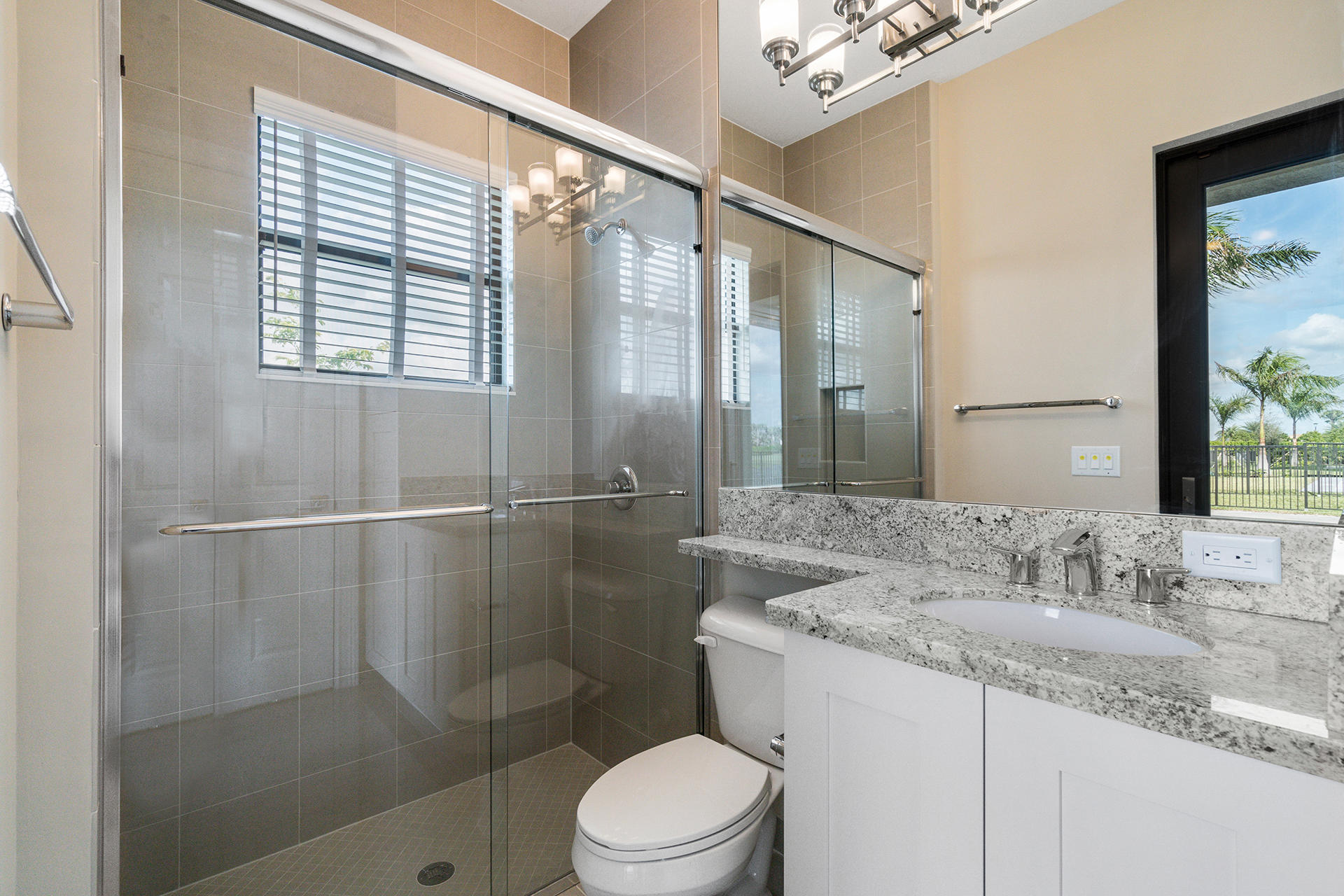 17334 Rosella Road Boca Raton, FL 33496 - Photo 23 of 50 a bathroom with a granite countertop sink a toilet and shower