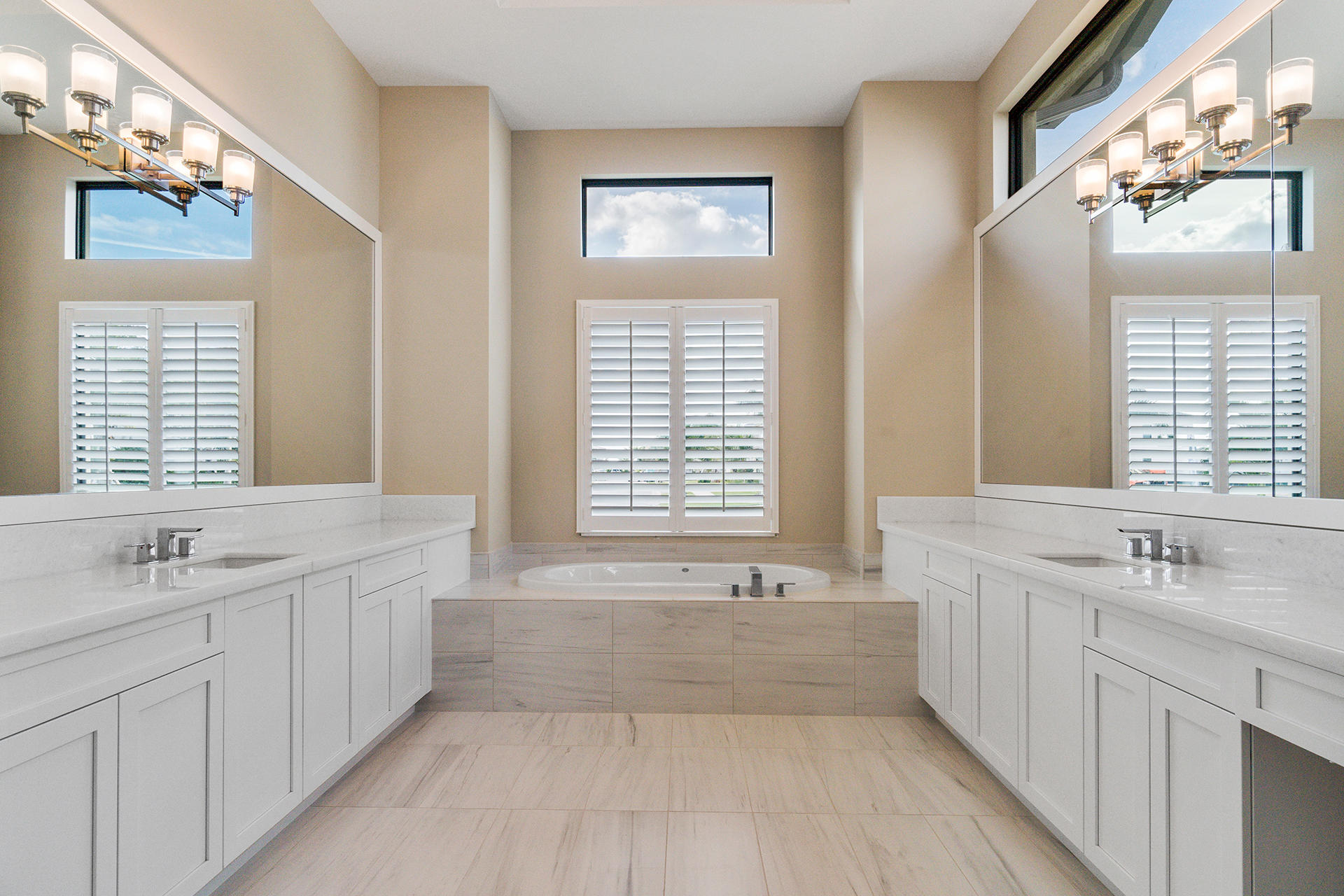 17334 Rosella Road Boca Raton, FL 33496 - Photo 25 of 50 a spacious bathroom with sinks mirror and a bathtub
