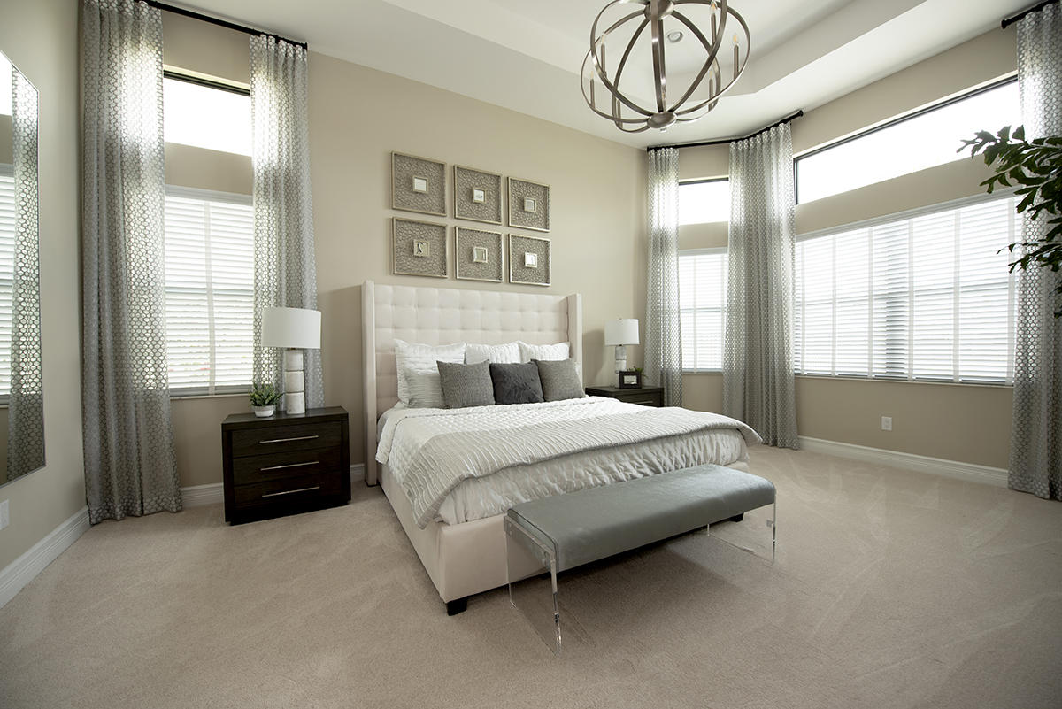 17334 Rosella Road Boca Raton, FL 33496 - Photo 7 of 50 a bedroom with a bed a chandelier and a large window