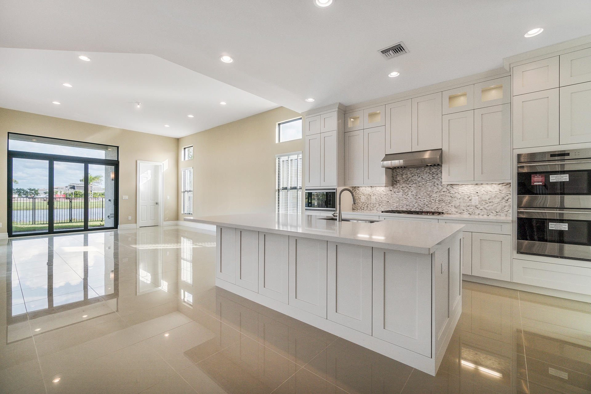 17334 Rosella Road Boca Raton, FL 33496 - Photo 9 of 50 a kitchen with stainless steel appliances granite countertop a sink and cabinets