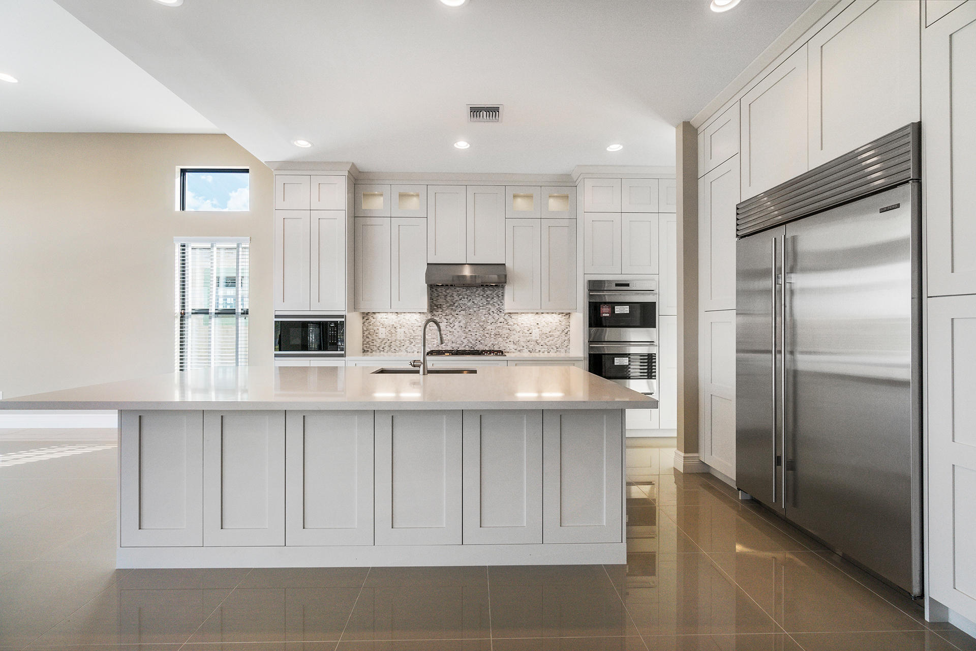 17334 Rosella Road Boca Raton, FL 33496 - Photo 10 of 50 a kitchen with white cabinets and refrigerator