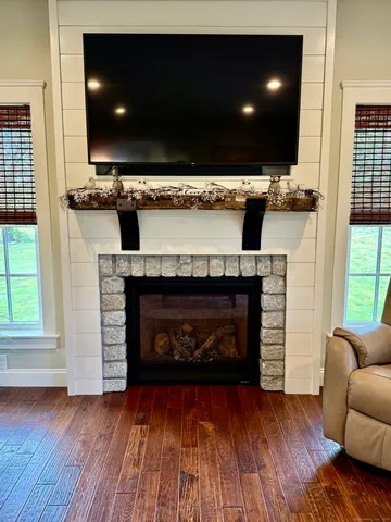 a living room with a flat screen tv and a fireplace